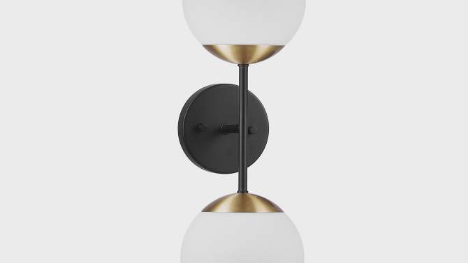 Celestia 2-Light Matte Black Wall Sconce with Antique Brass Accent Socket and Matte Opal Glass Shades - Globe Electric, 2 of 11, play video