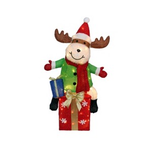 Season's Designs 3ft 3D Christmas Reindeer in Green Coat & Santa Hat Freestanding Indoor/Outdoor Decoration, Red Gift Box, Polyester, Warm White LED - 1 of 1