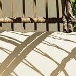 black steel frame + brown rattan + white plush cushion