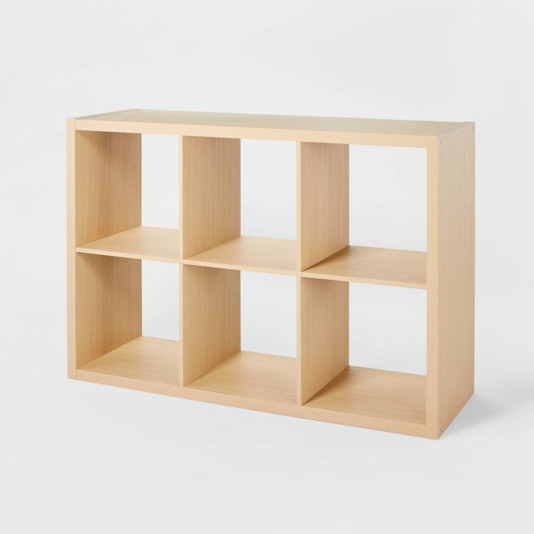 Natural wood-colored cube organizer with six open shelves arranged in two rows of three.