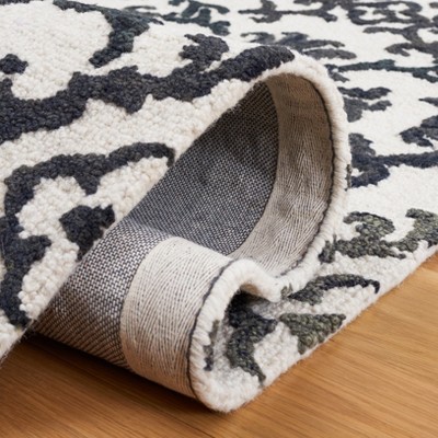 Handmade Black and Ivory Wool Floral 8' x 10' Rug