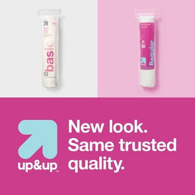 Two packages of cotton pads, one labeled "basic" in pink colored text and the other "regular" in white text on a pink background, with the phrase "New look. Same trusted quality." and a blue arrow logo below.