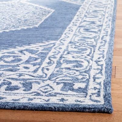 Blue and Ivory Tufted Wool 4' x 6' Area Rug