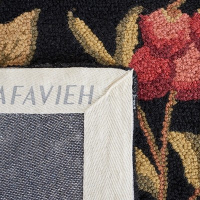 Handmade Black Floral Wool Oval Tufted Rug