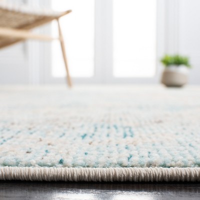Ivory and Teal 4' x 6' Synthetic Non-Slip Rectangular Rug