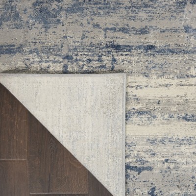 Blue and Ivory Abstract Synthetic Area Rug 5'3" x 7'3"