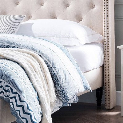 Elegant Beige Queen Bed with Tufted Upholstery and Nailhead Trim