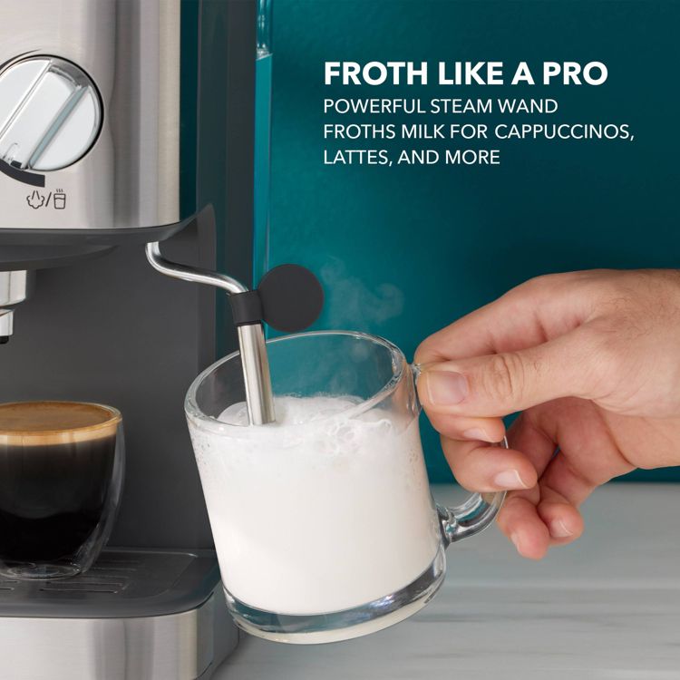 A person uses the steam wand of an espresso maker to froth milk in a clear glass mug, with text reading "Froth Like a Pro" and "Powerful steam wand froths milk for cappuccinos, lattes, and more."