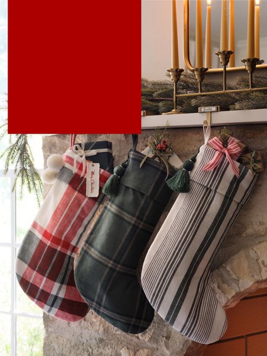 Stuffed plaid stockings hang on fireplace mantel.