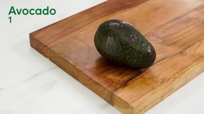 Green Avocado and a Knife on Brown Wooden Chopping Board · Free Stock Photo