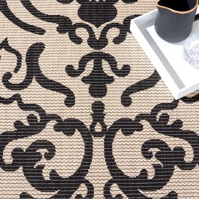 Black and Sand Synthetic Stain-Resistant Indoor/Outdoor Rug