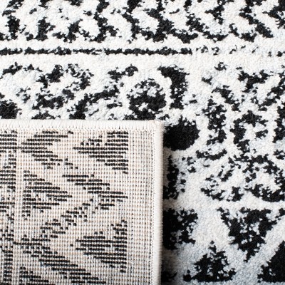 Ivory and Charcoal Geometric 9' x 12' Synthetic Area Rug