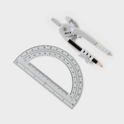 A gray colored compass with a pencil and a clear protractor with degree markings are placed on a white surface.