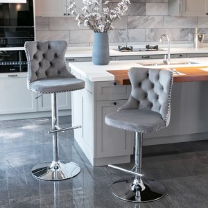The two modern gray velvet swivel bar stools are height, backrest, and footrest adjustable. - 1 of 4