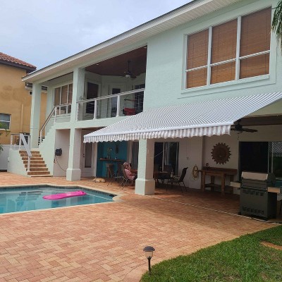 Grey and White Striped Retractable Patio Awning with White Frame