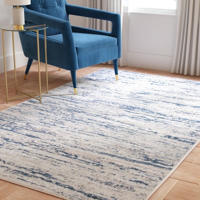 Ivory and Blue Abstract 6&#039; x 9&#039; Stain-Resistant Synthetic Rug