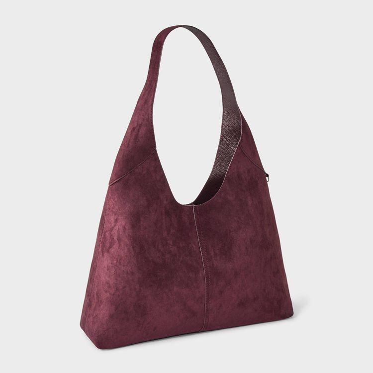 A burgundy colored shoulder bag with a single strap and a textured surface.