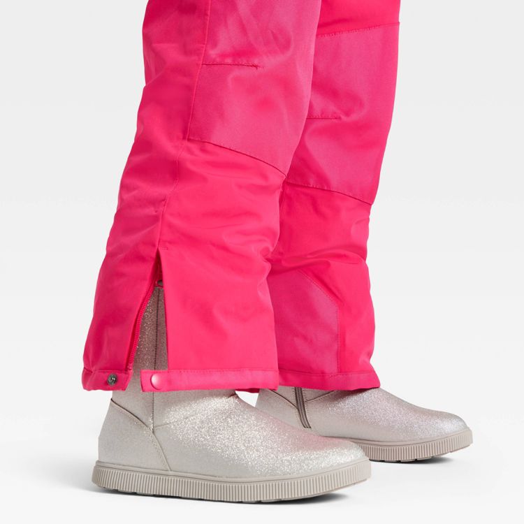 Bright pink colored snow pants with a side zipper and snap closure, paired with silver colored glitter boots.