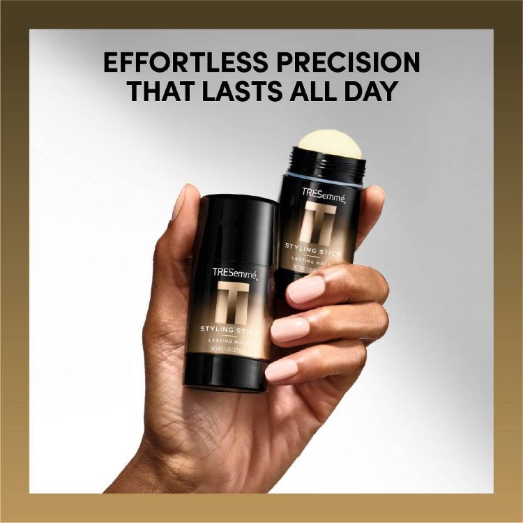A hand holding two black colored TRESemmé styling sticks with the text "EFFORTLESS PRECISION THAT LASTS ALL DAY" above.