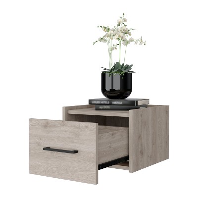 Nightstand with vase and books on top.