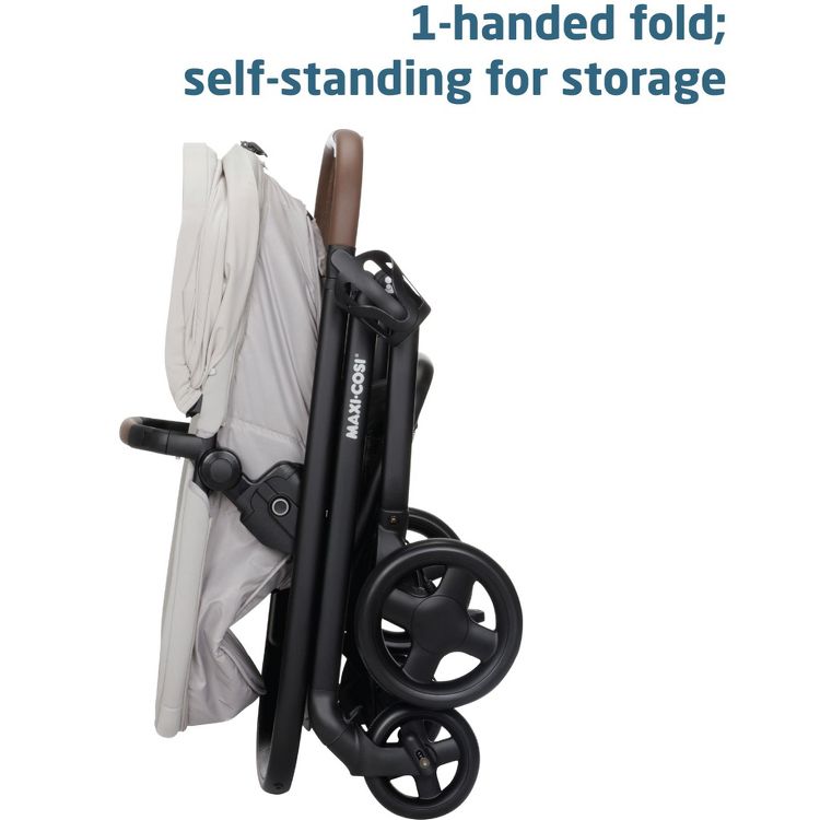 A folded stroller with black wheels and a light-colored seat, featuring a brown handle, shown in a self-standing position with the text "1-handed fold; self-standing for storage" above.