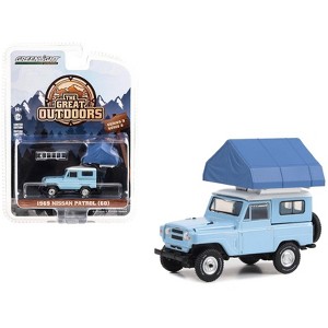 1969 Nissan Patrol (60) Light Blue with White Top and Camp'otel Cartop Sleeper Tent 1/64 Diecast Model Car by Greenlight - 1 of 3