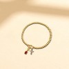 Free bird Cross Birthstone Bracelet | Dainty 14K Gold Plated Cross Charm Bracelet | Stretchable Elastic Gold Beaded Bracelet - 3 of 4