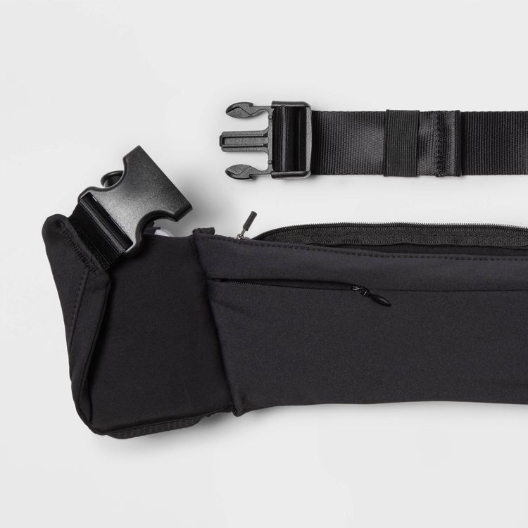 Black colored belt with a plastic buckle and zippered pocket.