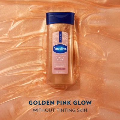 Vaseline Sunlit Glow Gel Oil, 6.8 fl oz. Set on shimmering golden pink backdrop, offers glow without tinting skin. Elegant blue cap.
