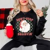Simply Sage Market Women's Graphic Sweatshirt Don't Stop Believin' Santa Checkered - 2 of 4