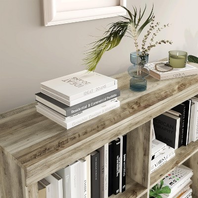 Close-up of top of bookshelf with books and decor objects