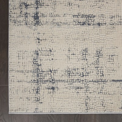 Ivory and Blue Abstract Synthetic 9x13 Area Rug