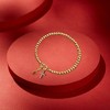 Free bird Cross Birthstone Bracelet | Dainty 14K Gold Plated Cross Charm Bracelet | Stretchable Elastic Gold Beaded Bracelet - 4 of 4