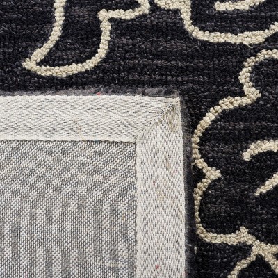 Handmade Black and Ivory Floral Wool Area Rug, 5' x 8'