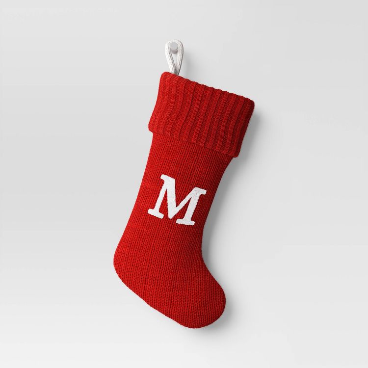 Red colored stocking with a white letter "M" and a loop for hanging.