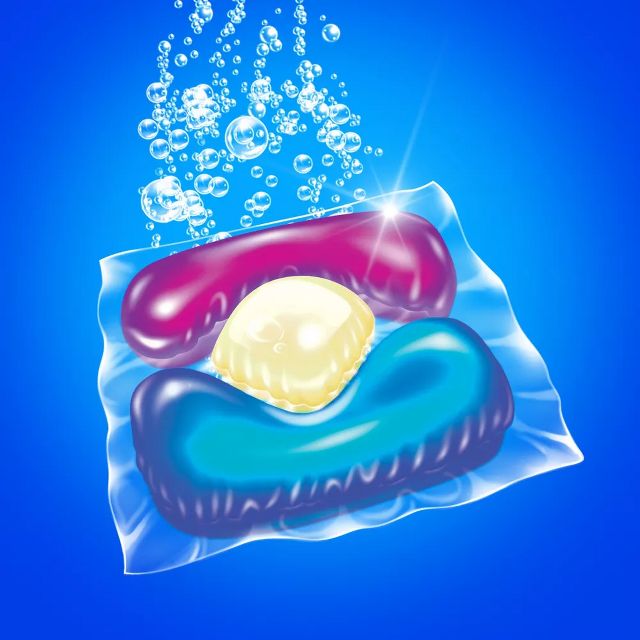 Laundry detergent pod with bubbles in water, showing multi-chamber detergent capsule.
