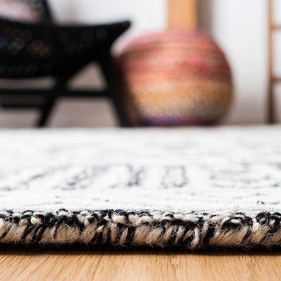 Handmade Abstract Black and Ivory Wool Round Rug 6'
