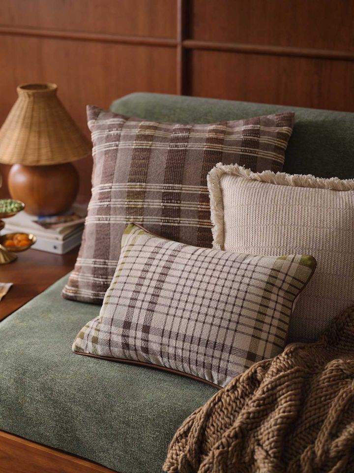 Plaid and textured pillows on accent chair