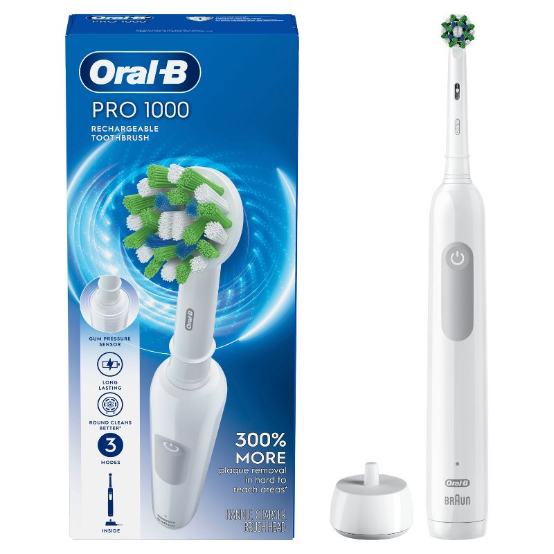 Oral-B Pro 1000 White Electric Toothbrush package. Includes Toothbrush, Cross Action Replacement Brush Head, and charger. Features image of an oscillating toothbrush. Removes 300% more plaque along the gumline.