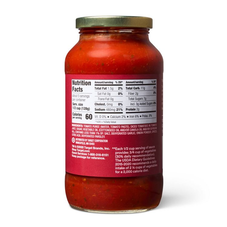 A jar of red colored sauce with a nutrition facts label showing details like total fat, sodium, and calories, along with a list of ingredients.