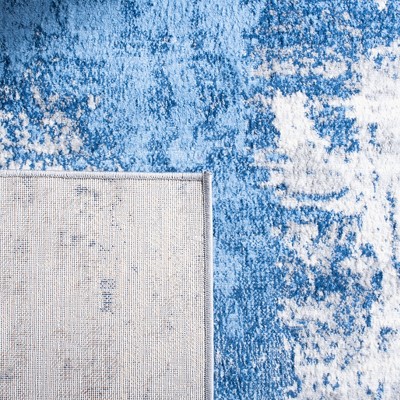 Blue and Ivory Abstract Synthetic Area Rug, 5'3" x 7'6"
