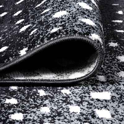 Abstract Antelope 8' x 10' Black and Ivory Synthetic Area Rug