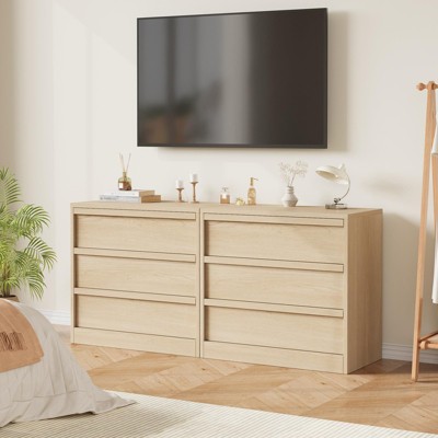 Two-drawer wide dresser with TV above in a bedroom setting