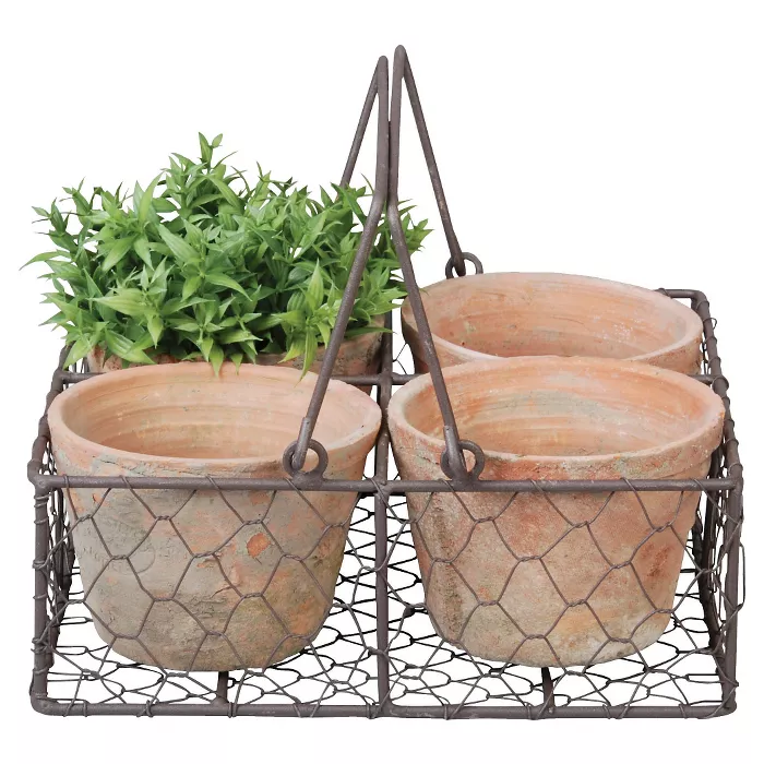 Terracotta pots in wire basket.  Lovely Country French and Euro Country decor and furniture items on Hello Lovely! #frenchfarmhouse #frenchdecor #homedecor #interiordesign #frenchcountry #terracotta #pots