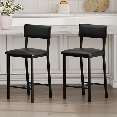 Two black bar stools placed in front of a kitchen counter