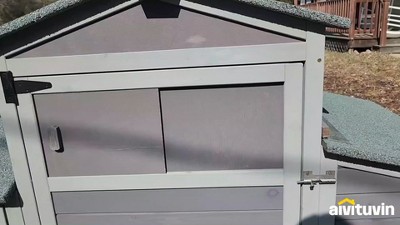 Gray and White Mobile Chicken Coop with Metal Wheels