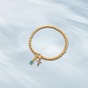 Free bird Cross Birthstone Bracelet | Dainty 14K Gold Plated Cross Charm Bracelet | Stretchable Elastic Gold Beaded Bracelet - 3 of 4