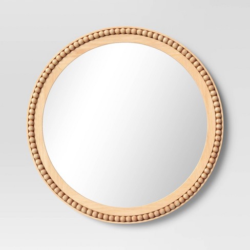 Cylindrical wood beads hand-sewn in a unique design over a metal frame.  Mirror comes with metal