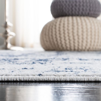 Ivory and Navy Abstract 8' x 10' Synthetic Area Rug