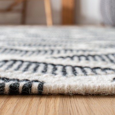 Nomadic Essence Handwoven Black and Cream Wool Area Rug, 5' x 8'